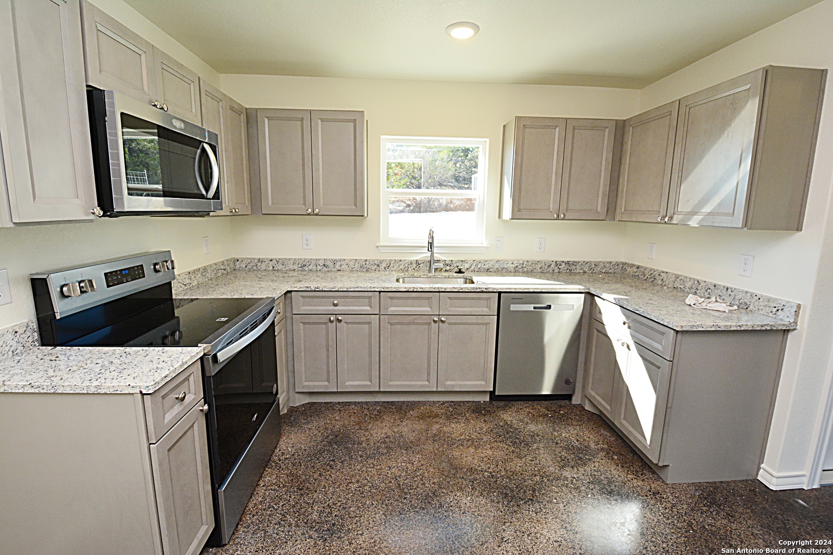 1559 Golf Course Drive Spring Branch, TX 78070 - Photo 3 of 8 a kitchen with a sink stove and microwave