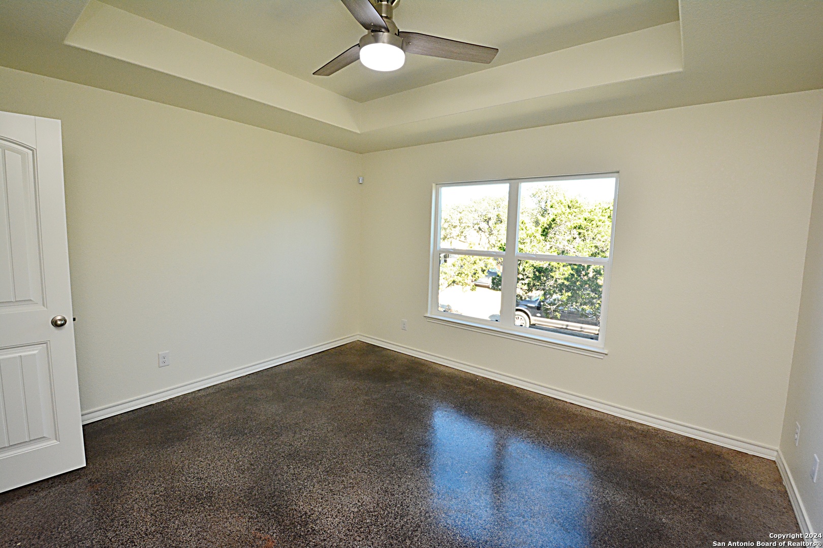1559 Golf Course Drive Spring Branch, TX 78070 - Photo 4 of 8 an empty room with a window and a fan