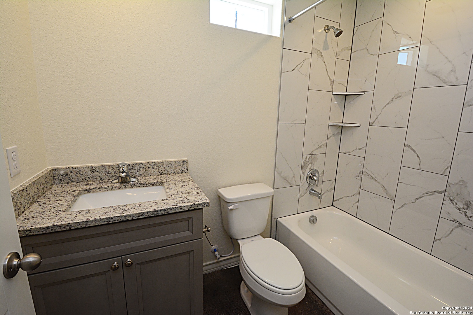 1559 Golf Course Drive Spring Branch, TX 78070 - Photo 7 of 8 a bathroom with a granite countertop toilet and a sink