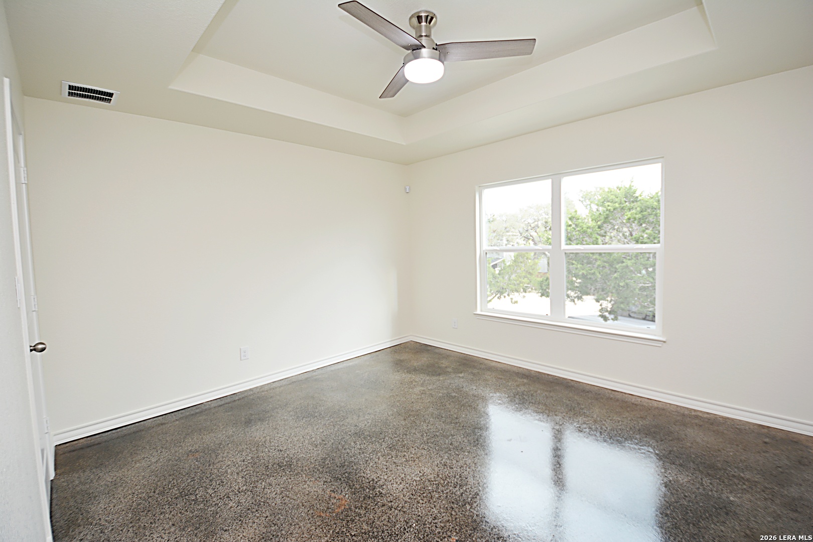 1559 Golf Course Drive Spring Branch, TX 78070 - Photo 9 of 15 an empty room with a window and ceiling fan