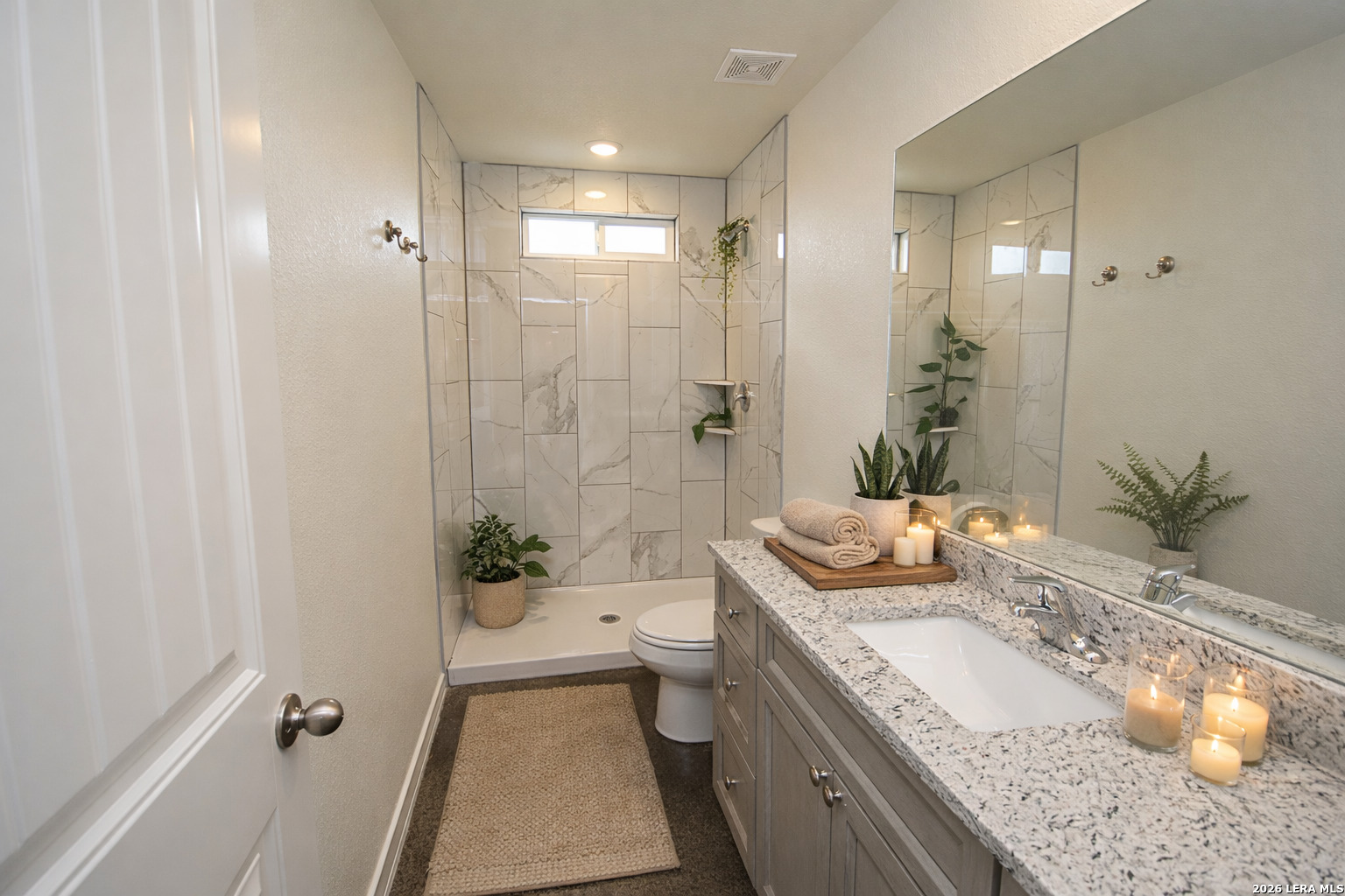1559 Golf Course Drive Spring Branch, TX 78070 - Photo 10 of 15 a bathroom with a granite countertop sink a toilet a mirror and shower