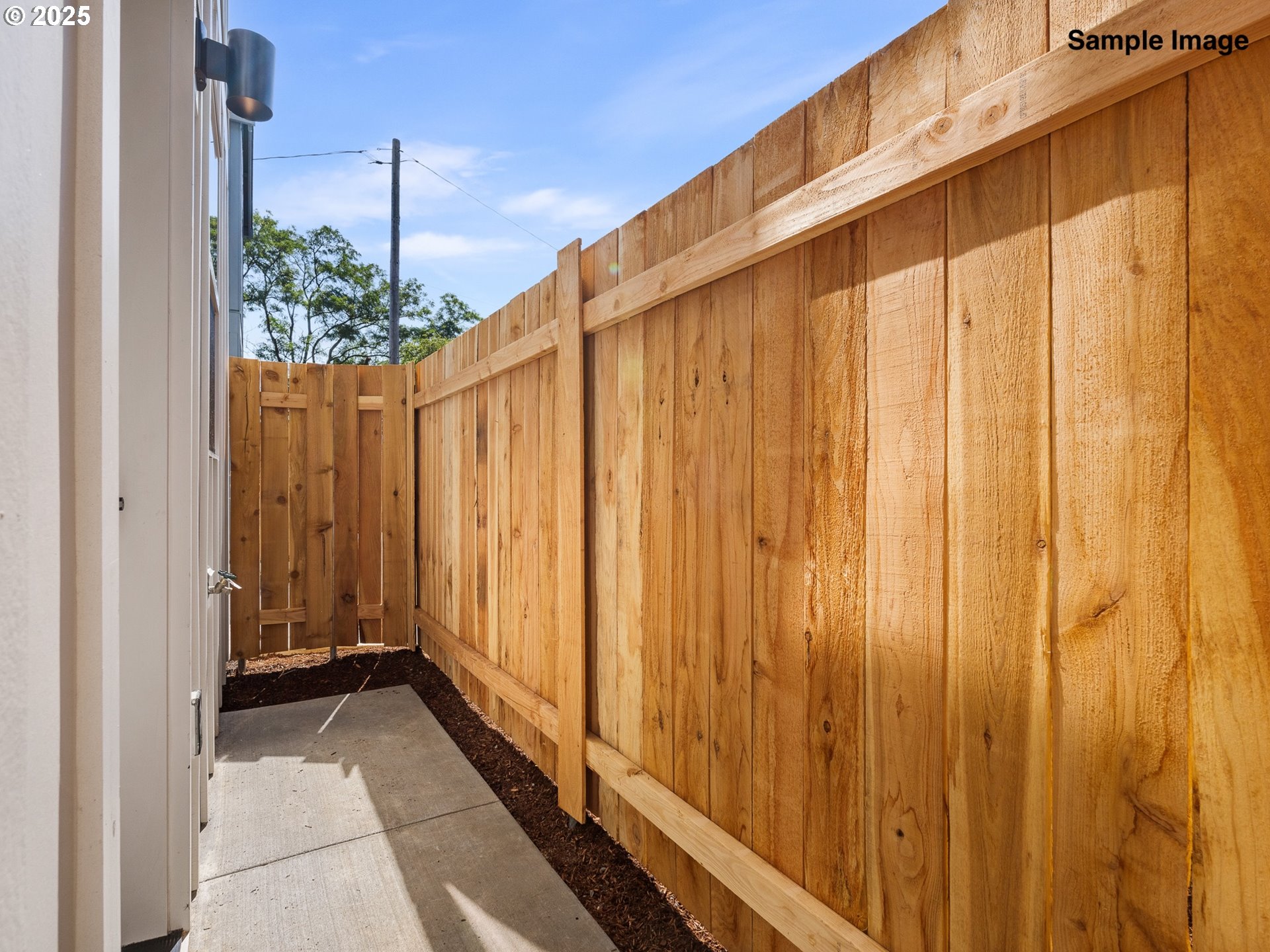 4350 Northeast Going Street Portland, OR 97218 - Photo 13 of 15 a view of a back yard with a wooden fence