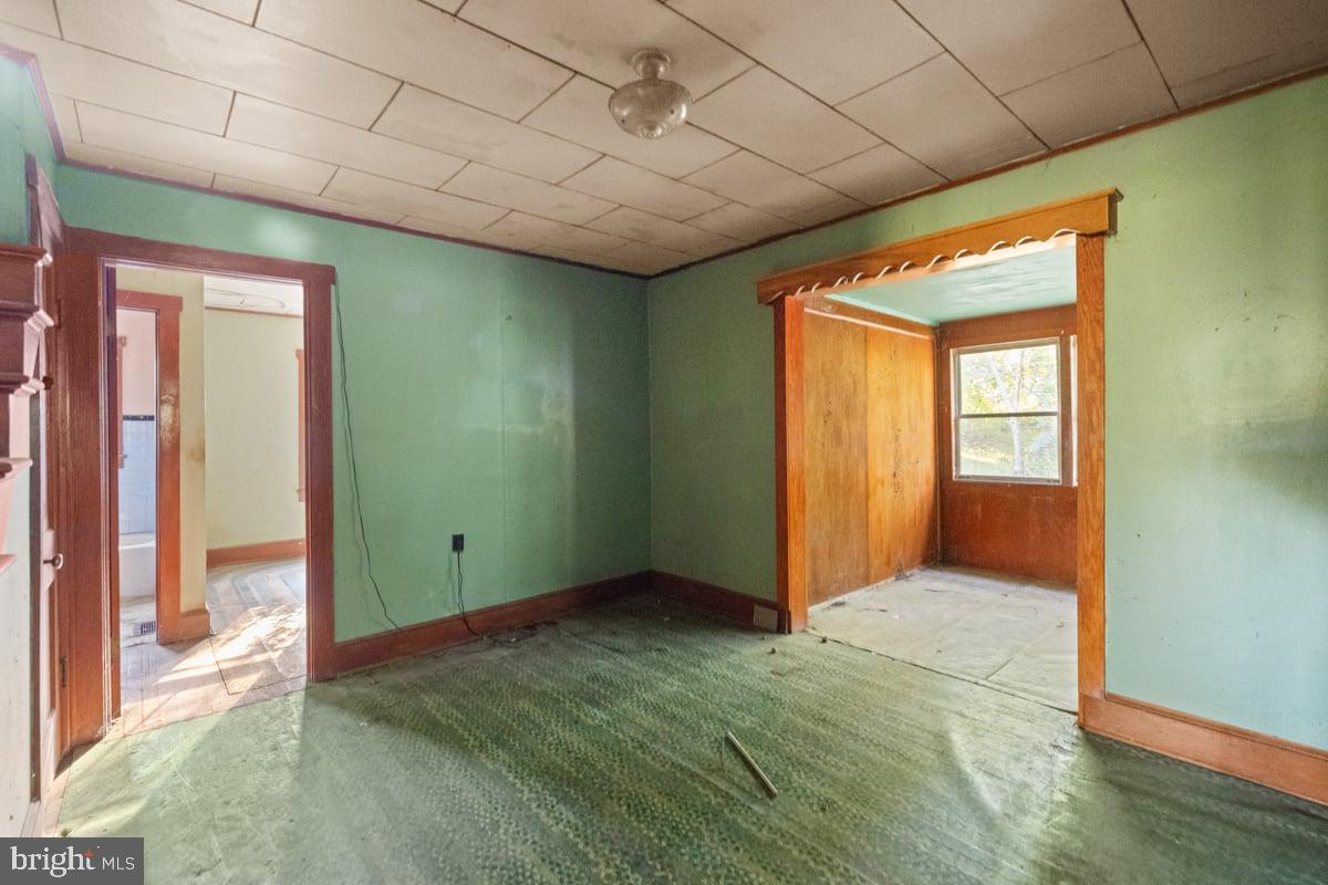 7189 Middle Road Middletown, VA 22645 - Photo 10 of 30 a view of an empty room with wooden floor and a window