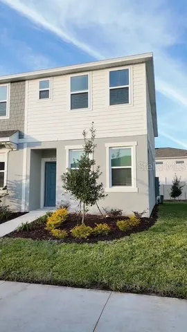 a front view of a house with a garden and yard