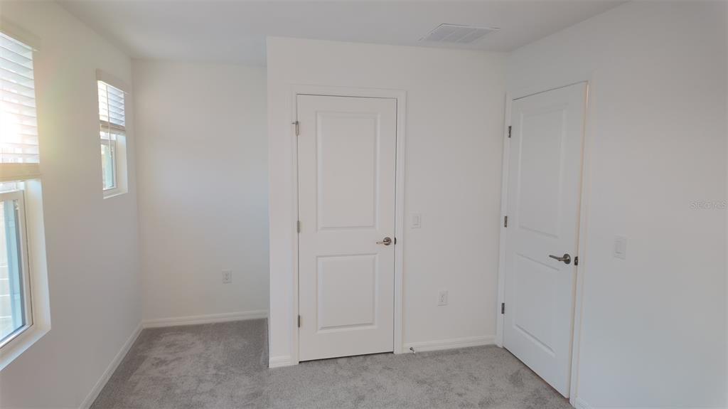 3240 Skyline Loop Kissimmee, FL 34758 - Photo 12 of 26 an empty room with windows