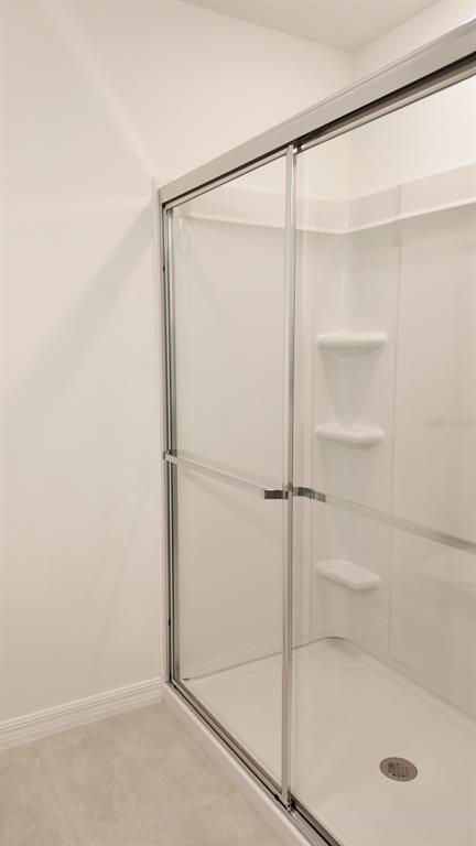 3240 Skyline Loop Kissimmee, FL 34758 - Photo 16 of 26 a bathroom with a glass shower