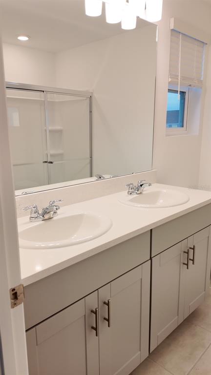 3240 Skyline Loop Kissimmee, FL 34758 - Photo 20 of 26 a bathroom with a sink and a mirror