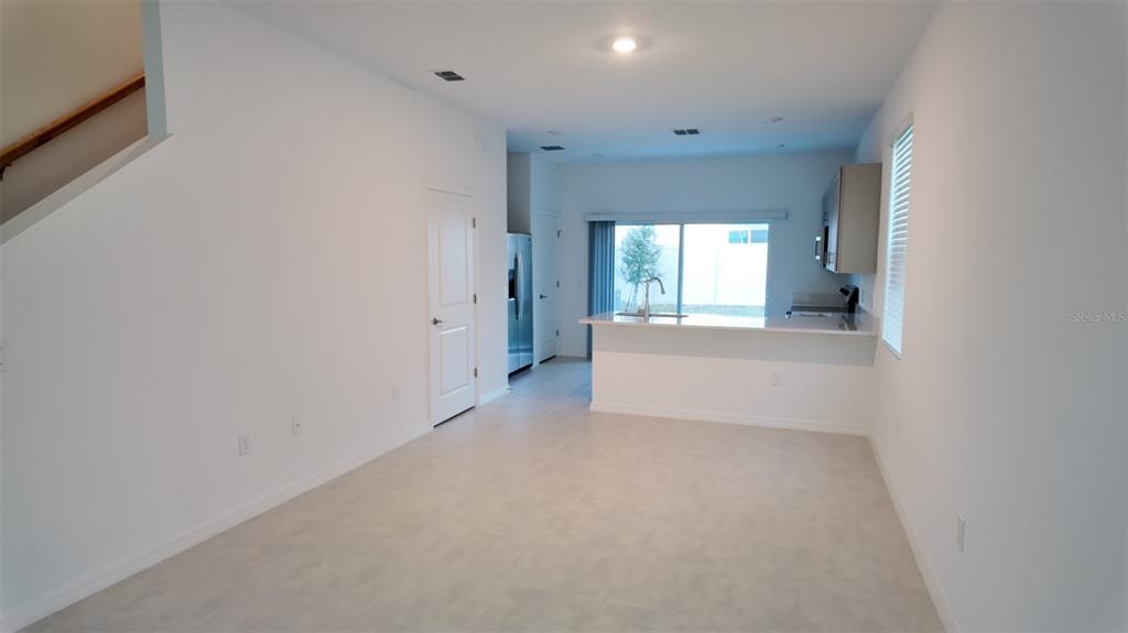 3240 Skyline Loop Kissimmee, FL 34758 - Photo 8 of 26 a view of a big room with windows and chandelier