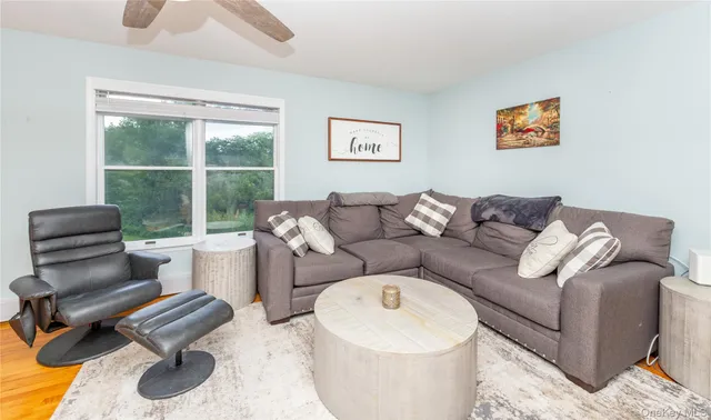 a living room with furniture and a floor to ceiling window