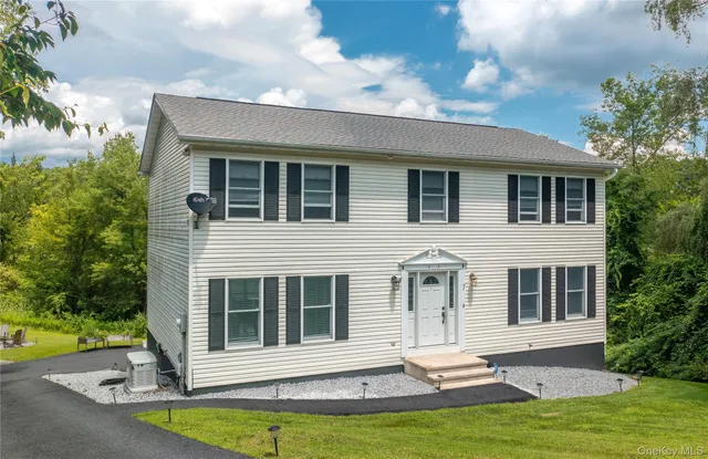 a front view of a house with a yard