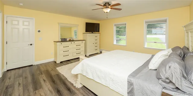 a view of a walk in closet with clothes and shoes