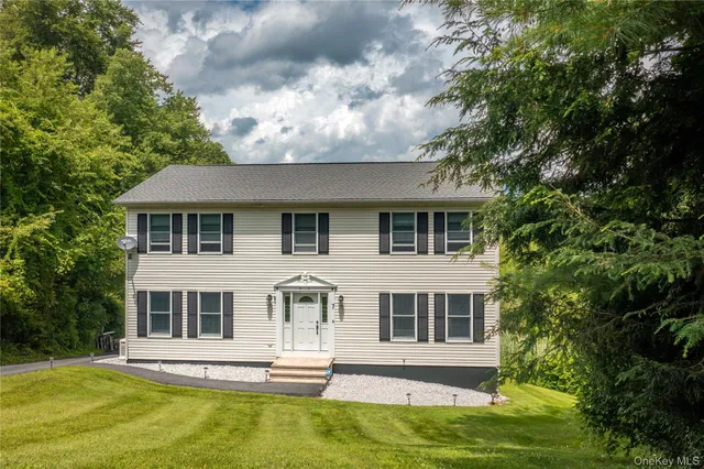 view of a yard with plants and large trees
