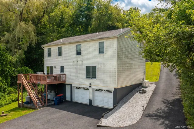 a view of house with backyard outdoor seating and trees