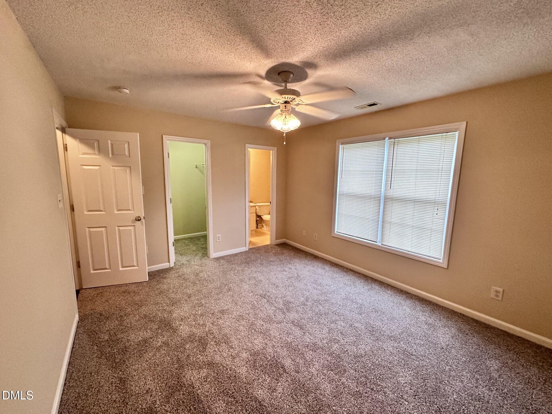 2112 Walnut Bluffs Lane Raleigh, NC 27610 - Photo 12 of 18 an empty room with windows and fan
