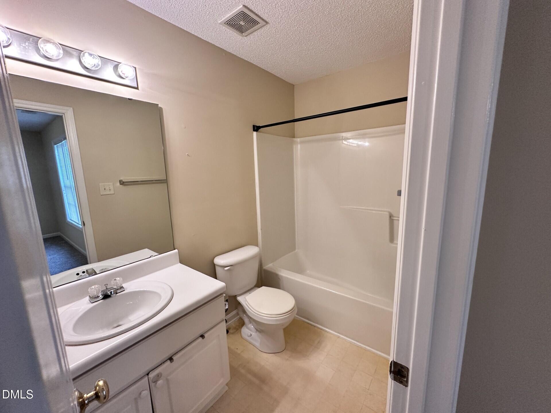 2112 Walnut Bluffs Lane Raleigh, NC 27610 - Photo 15 of 18 a bathroom with a sink a toilet and shower