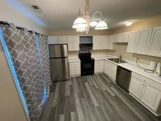 a kitchen with a sink stove and refrigerator