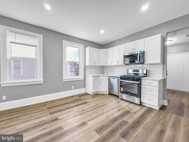 a kitchen with a refrigerator stove and microwave