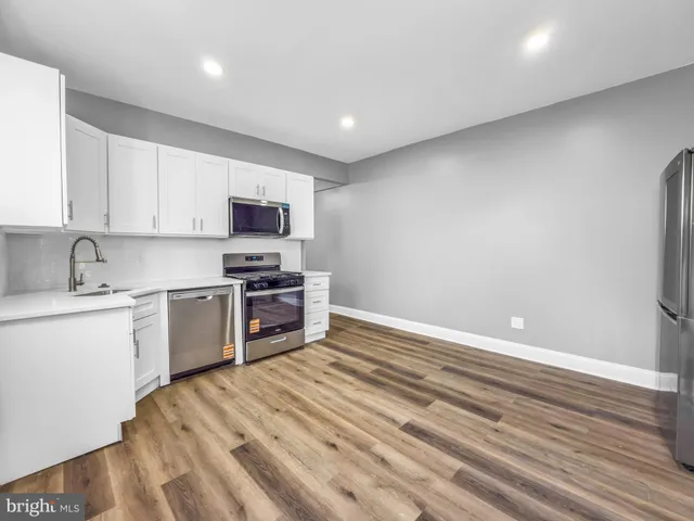 a kitchen with granite countertop a stove and a sink