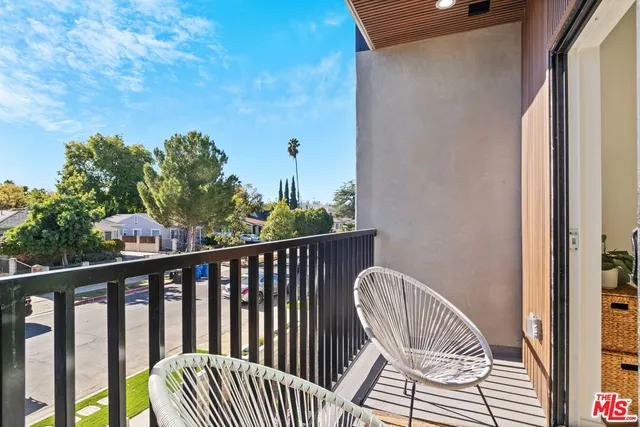 a view of a balcony with wooden floor