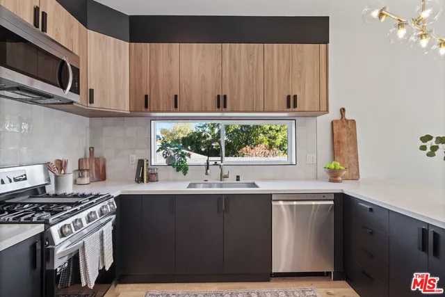 a kitchen with a sink cabinets and window