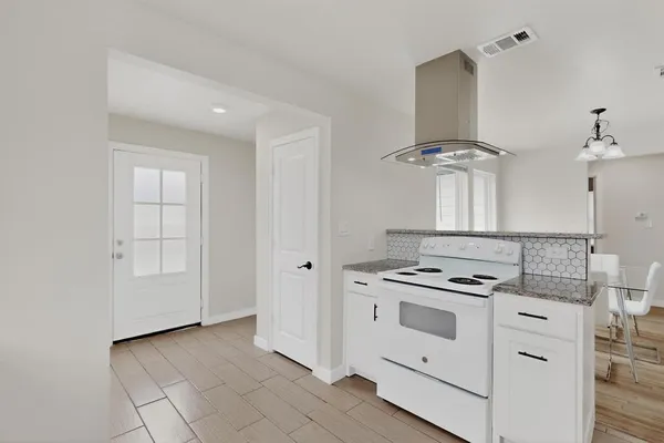 a kitchen with cabinets and appliances