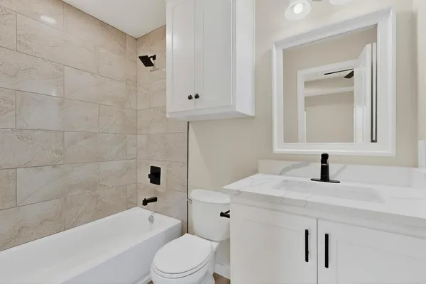 a bathroom with a sink a toilet and bathtub