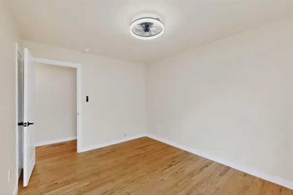 a view of room with wooden floor