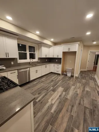 a large kitchen with kitchen island a sink stainless steel appliances and cabinets