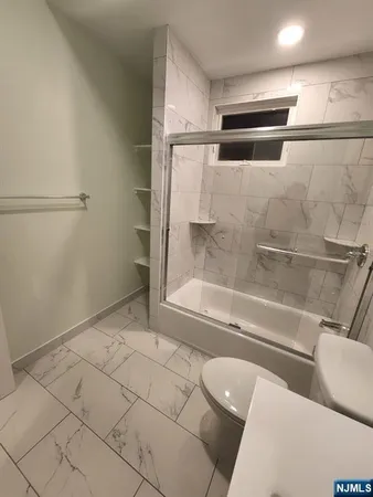 a bathroom with a bathtub and toilet