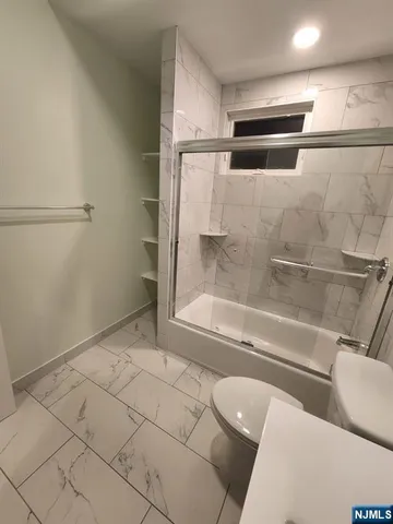 a bathroom with a bathtub and toilet
