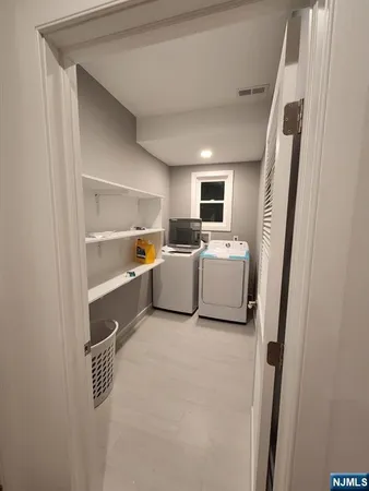 a utility room with sink dryer and washer