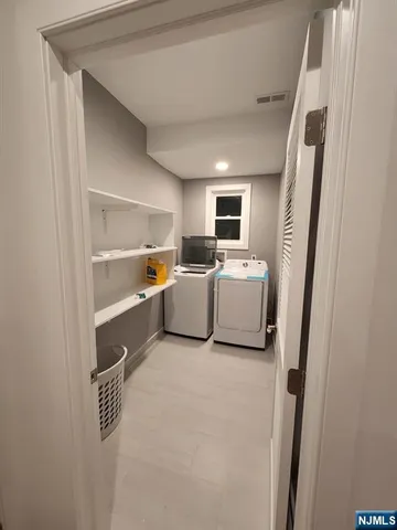 a utility room with sink dryer and washer