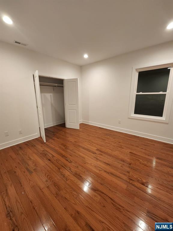 229 East 24th Street, Unit 1 Paterson, NJ 07514 - Photo 6 of 19 a view of an empty room with wooden floor and cabinet