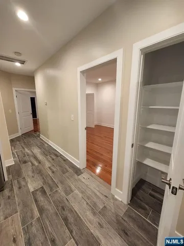 a view of an empty room and wooden floor