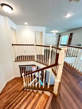 a view of staircase with wooden floor and a window