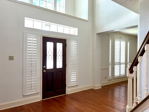 wooden floor in a hall with a window