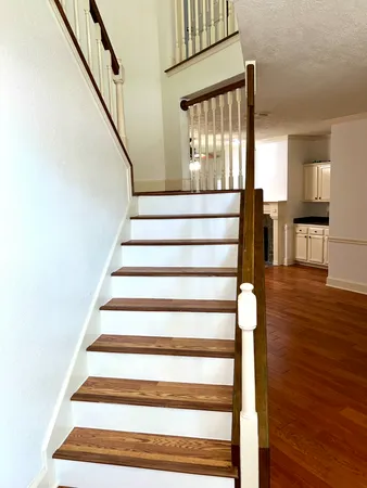 a view of entryway and hall with wooden floor