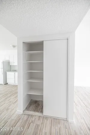 a view of walk in closet with wooden floor