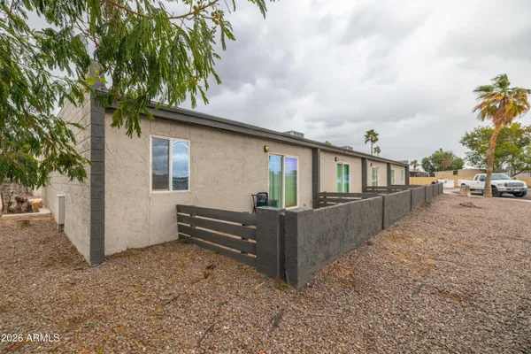 a view of a house with a yard and sitting area