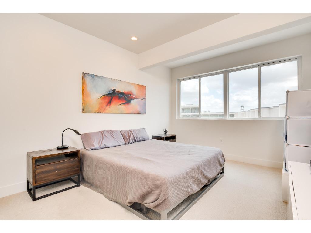 604 North Bluff Drive, Unit 125 Austin, TX 78745 - Photo 15 of 28 a bedroom with a bed and a painting on the wall