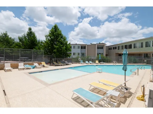 a view of a swimming pool with outdoor seating