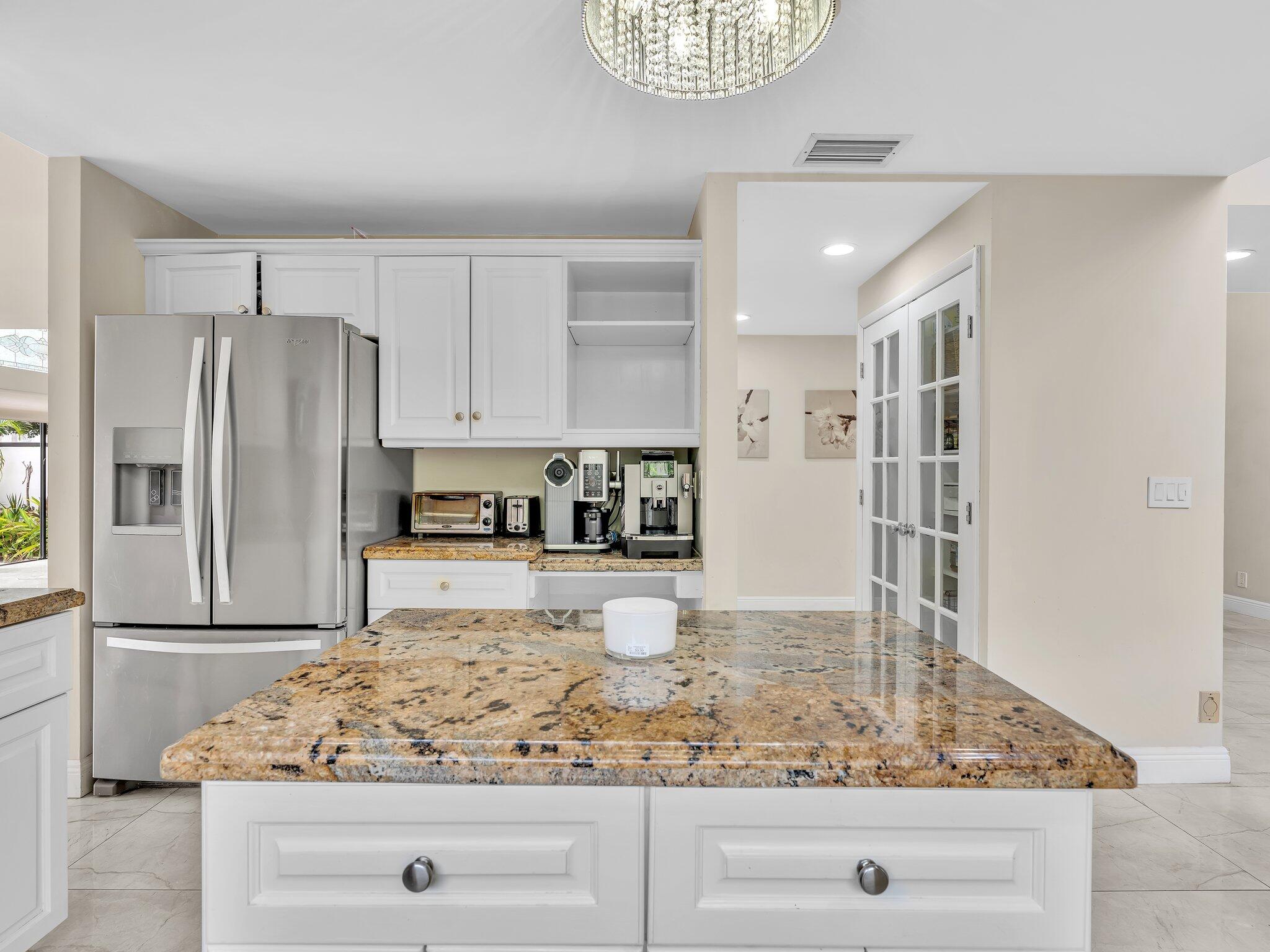 6400 Via Rosa Boca Raton, FL 33433 - Photo 15 of 81 a kitchen with stainless steel appliances granite countertop a refrigerator and stove