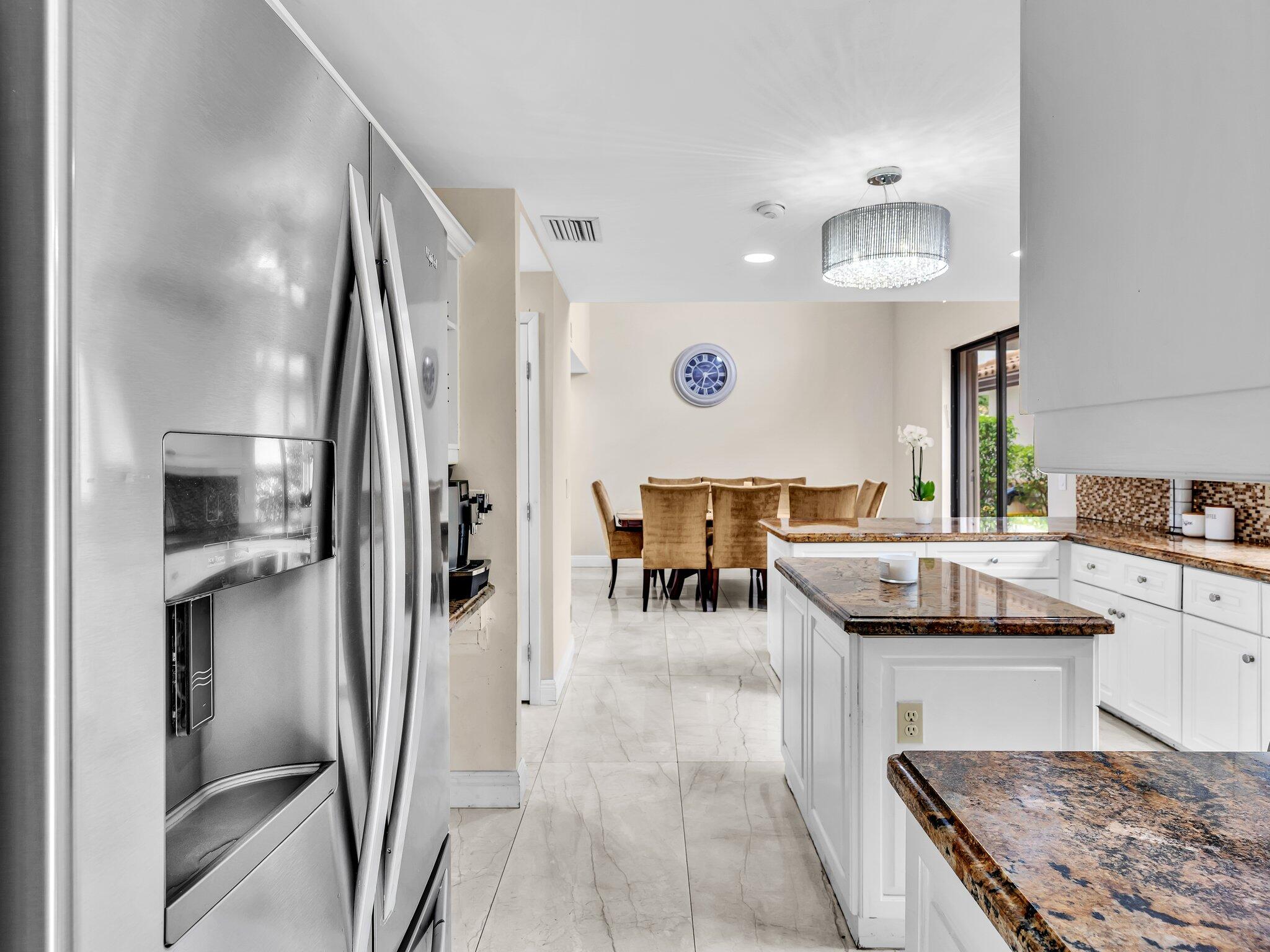 6400 Via Rosa Boca Raton, FL 33433 - Photo 19 of 81 a kitchen with stainless steel appliances granite countertop a refrigerator a stove and a sink