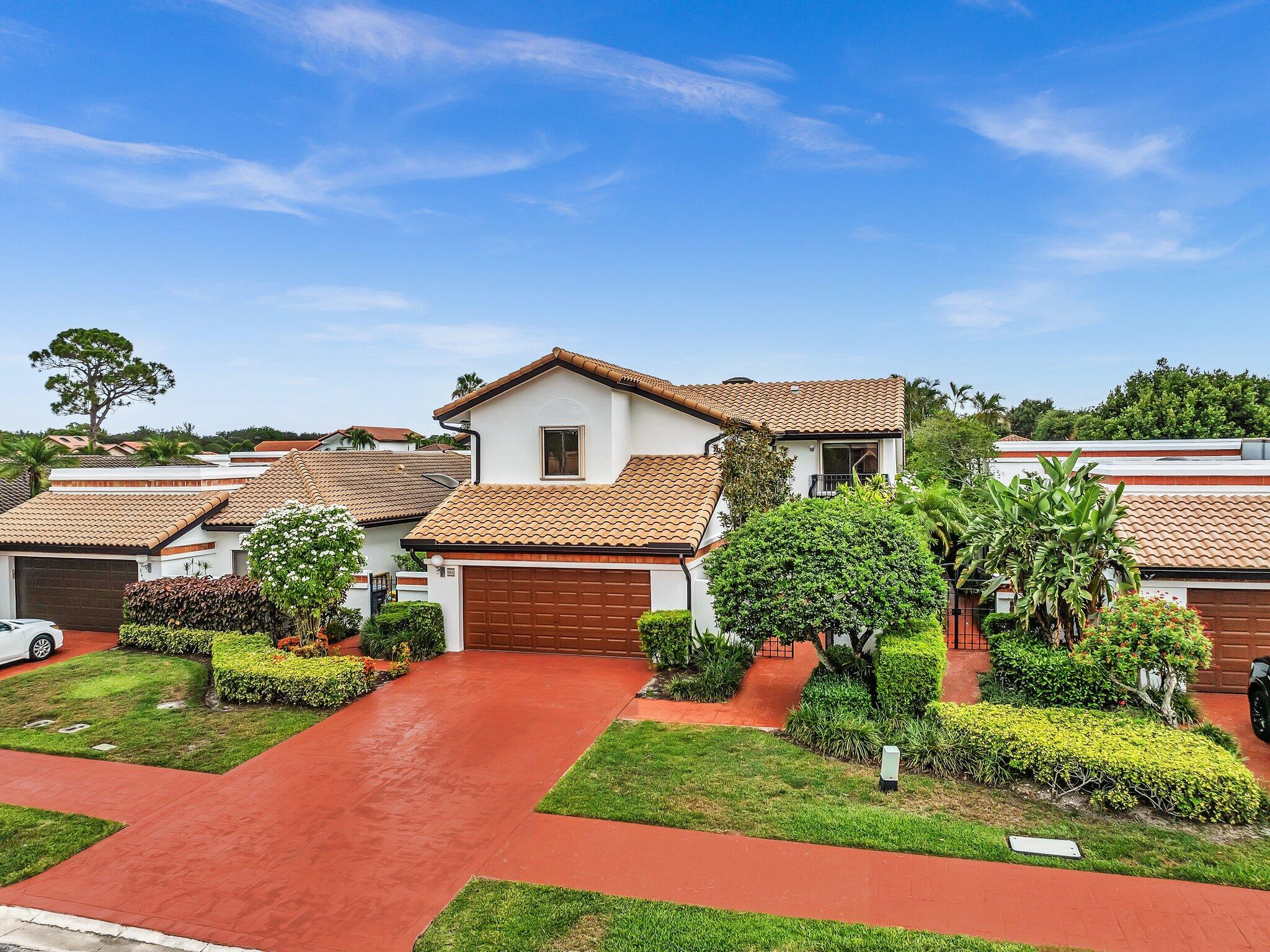 6400 Via Rosa Boca Raton, FL 33433 - Photo 4 of 81 a front view of a house with a yard and potted plants