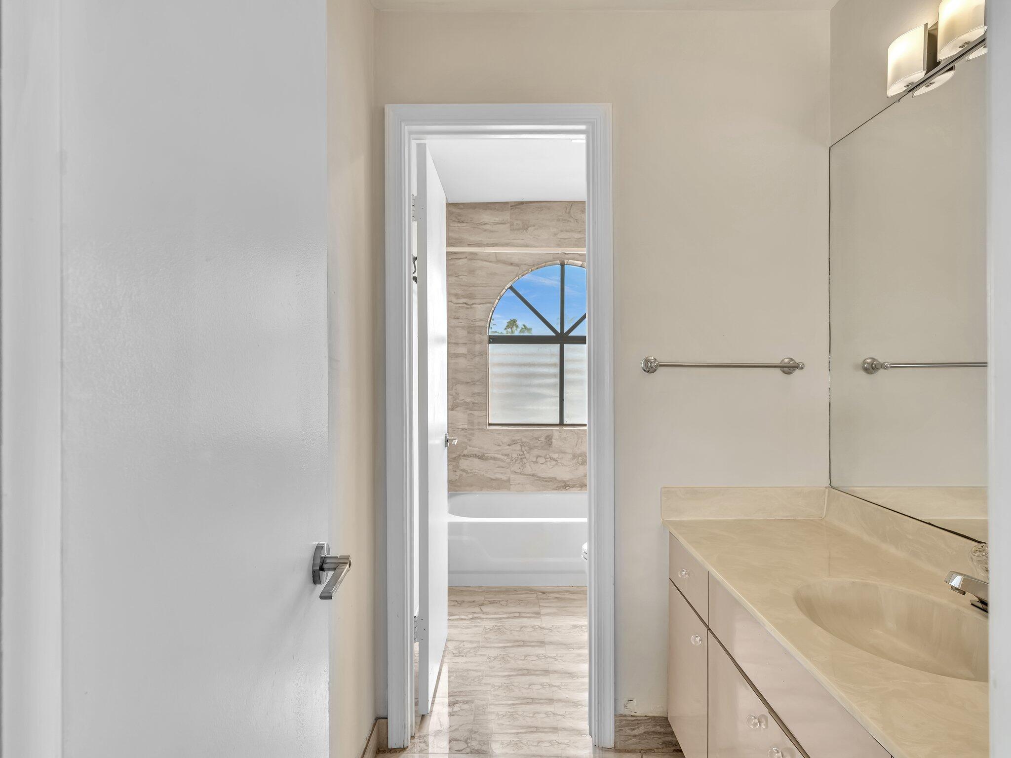 6400 Via Rosa Boca Raton, FL 33433 - Photo 50 of 81 a bathroom with a tub sink and vanity
