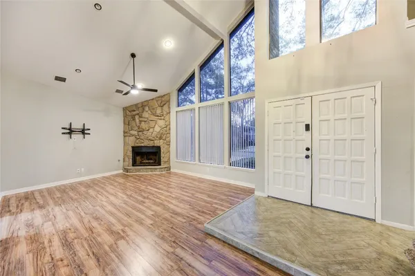 a view of empty room with wooden floor and fireplace