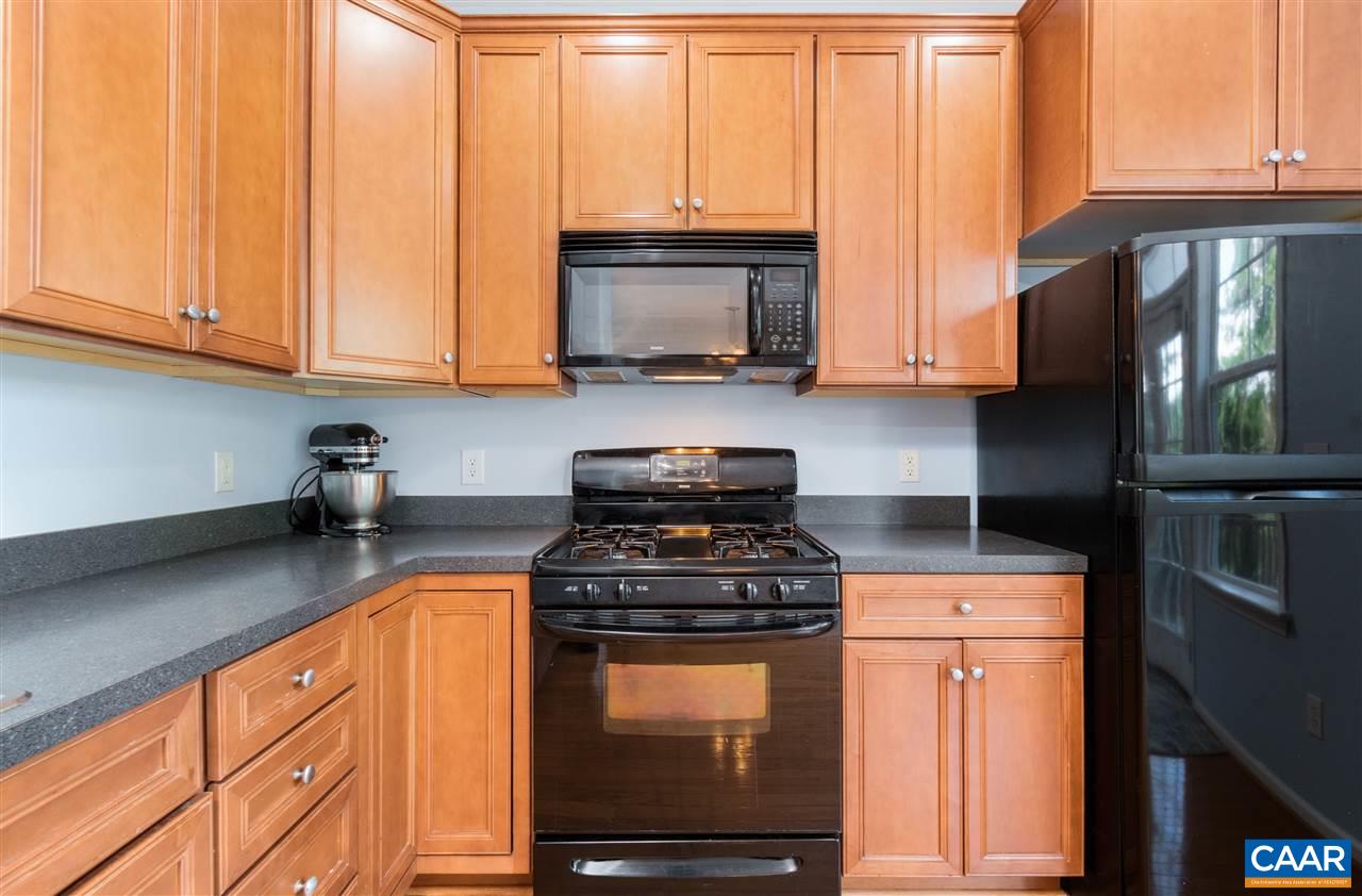 1313 Stoney Ridge Road Charlottesville, VA 22902 - Photo 14 of 38 a kitchen with granite countertop a stove a sink and a microwave