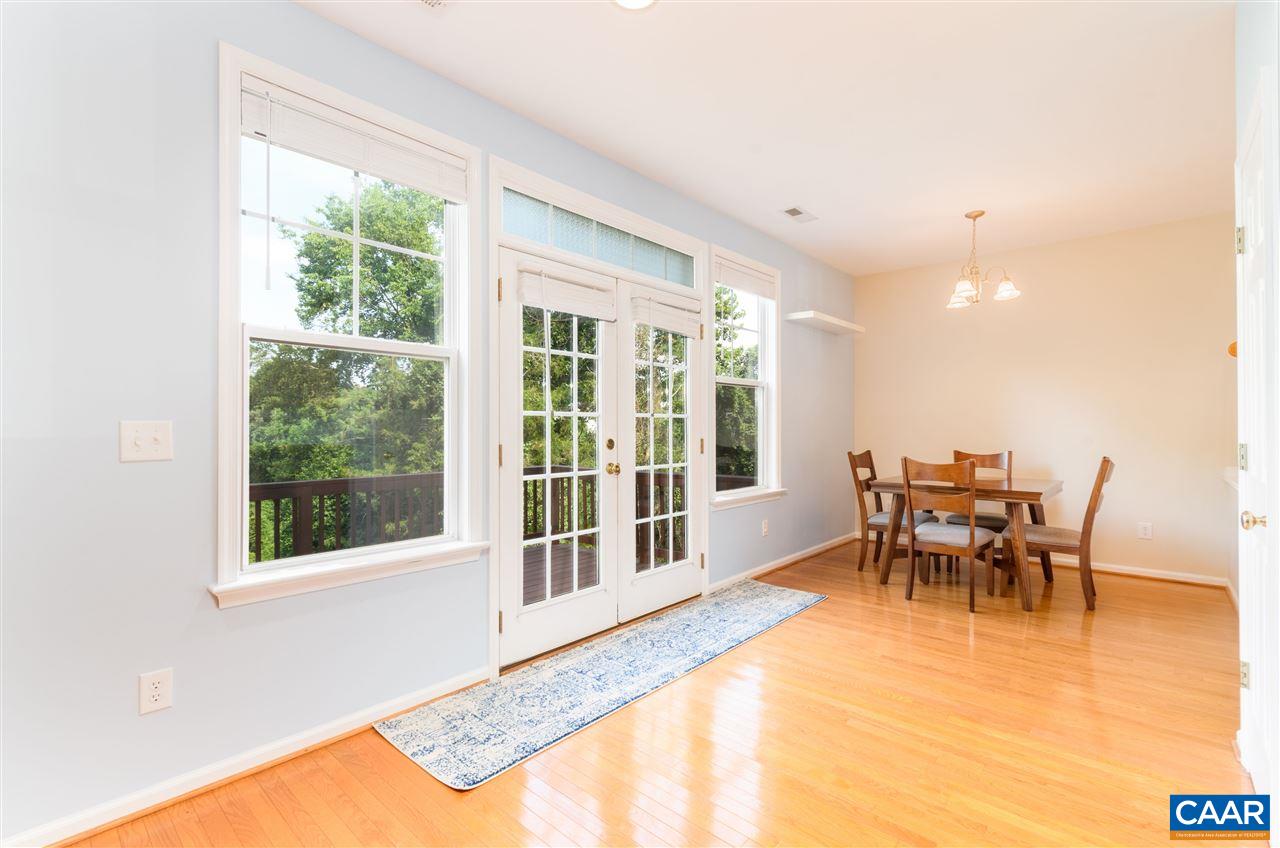 1313 Stoney Ridge Road Charlottesville, VA 22902 - Photo 16 of 38 a dining room with furniture a rug and a large window