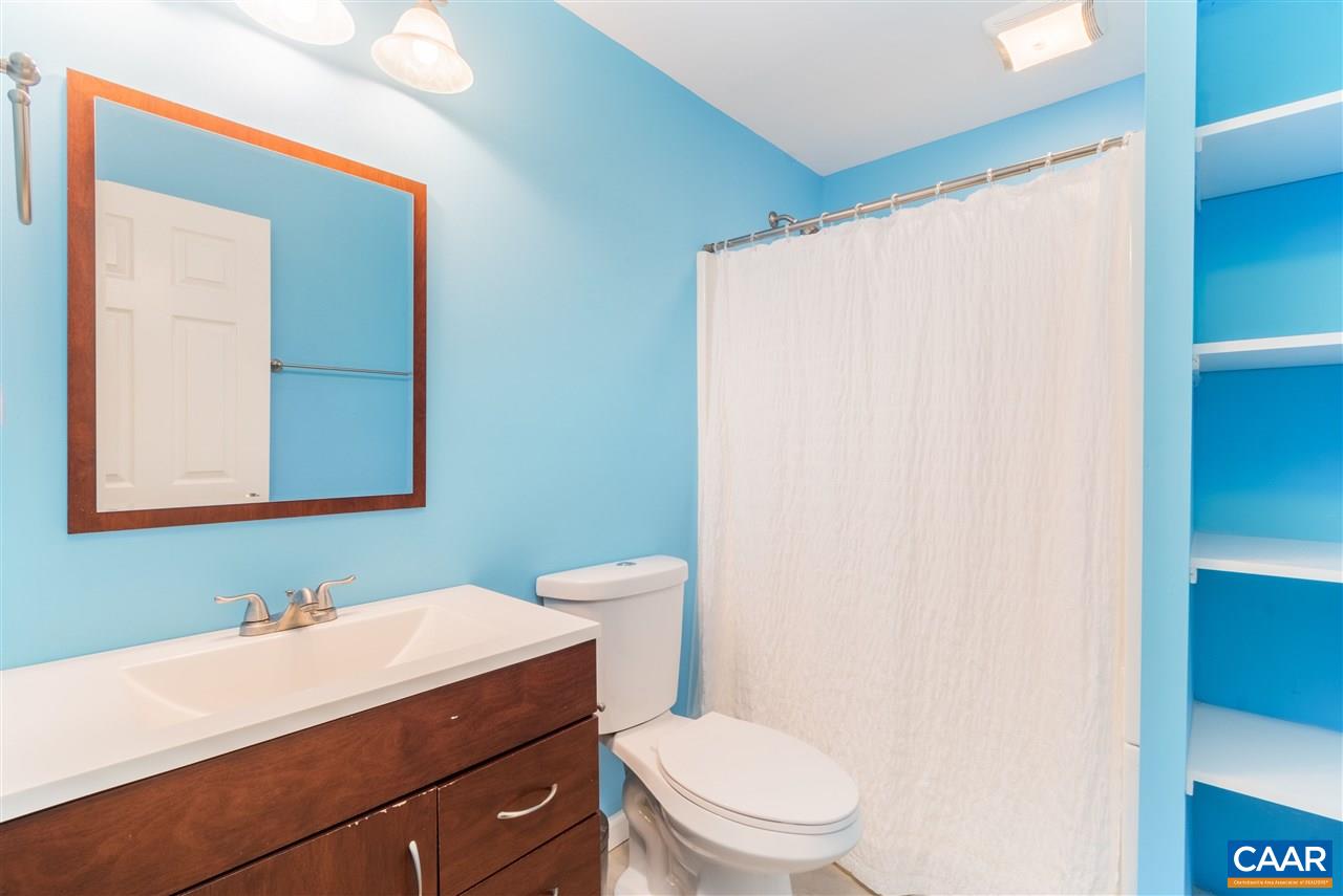 1313 Stoney Ridge Road Charlottesville, VA 22902 - Photo 35 of 38 a bathroom with a sink a toilet and mirror