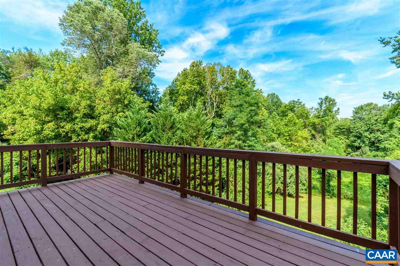 1313 Stoney Ridge Road Charlottesville, VA 22902 - Photo 5 of 38 a balcony with wooden floor and trees in the back